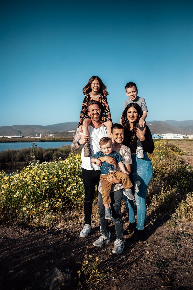 A family in Ensenada with two adults holding four children in a field