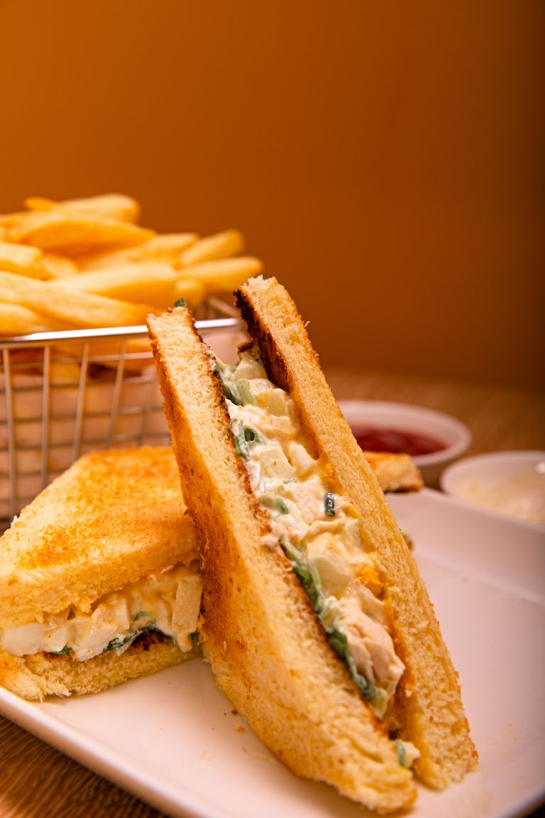 Perfectly toasted chicken sandwich with crispy fries, ideal for snack lovers.