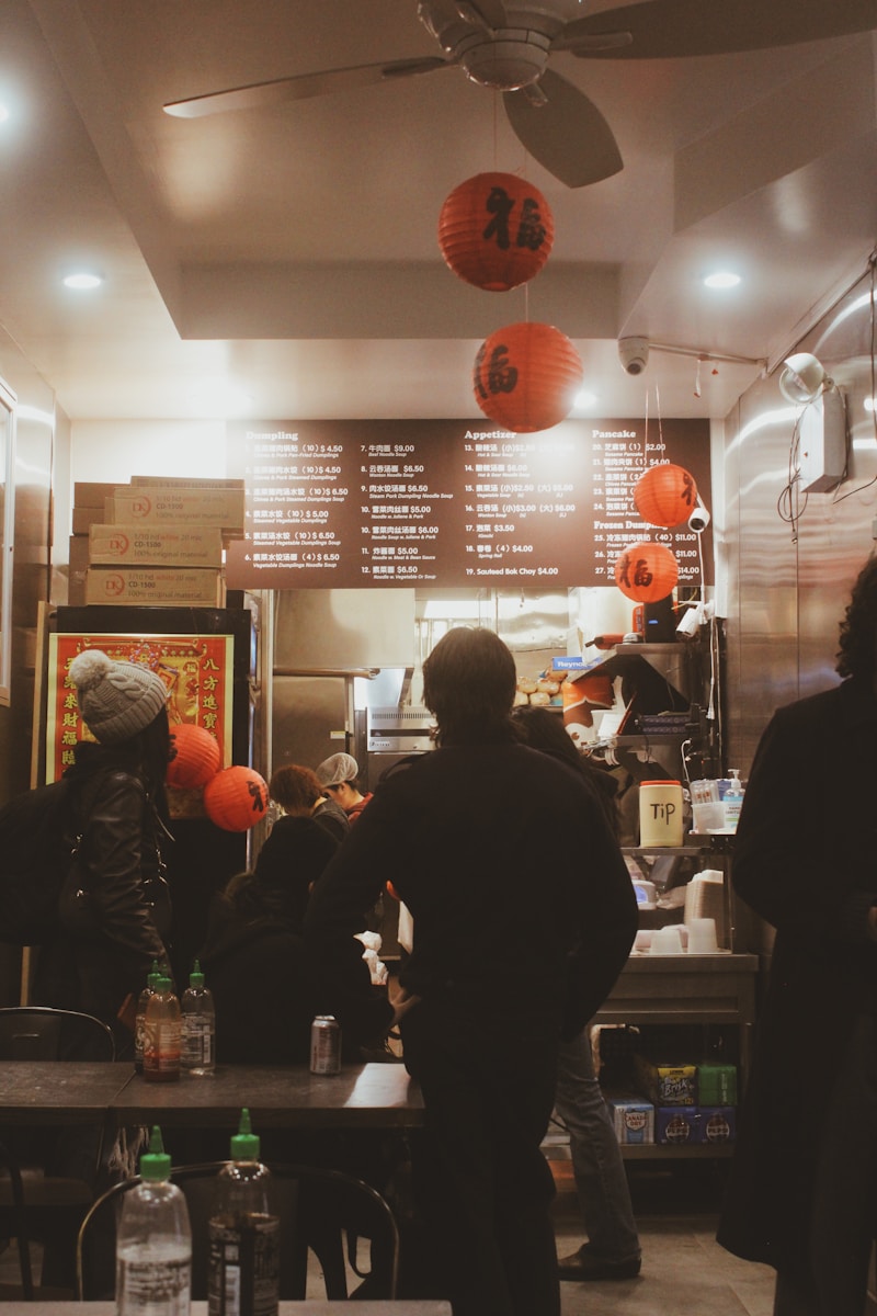 People ordering food at a restaurant with lanterns