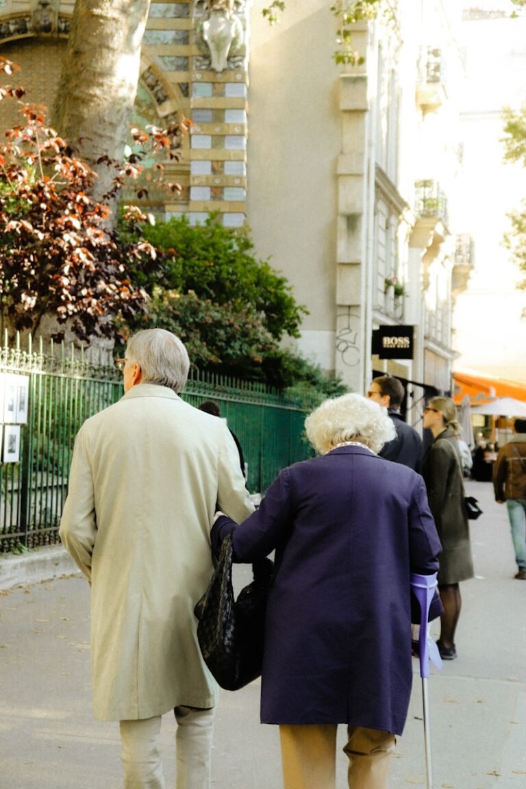 a couple of people walking down a sidewalk