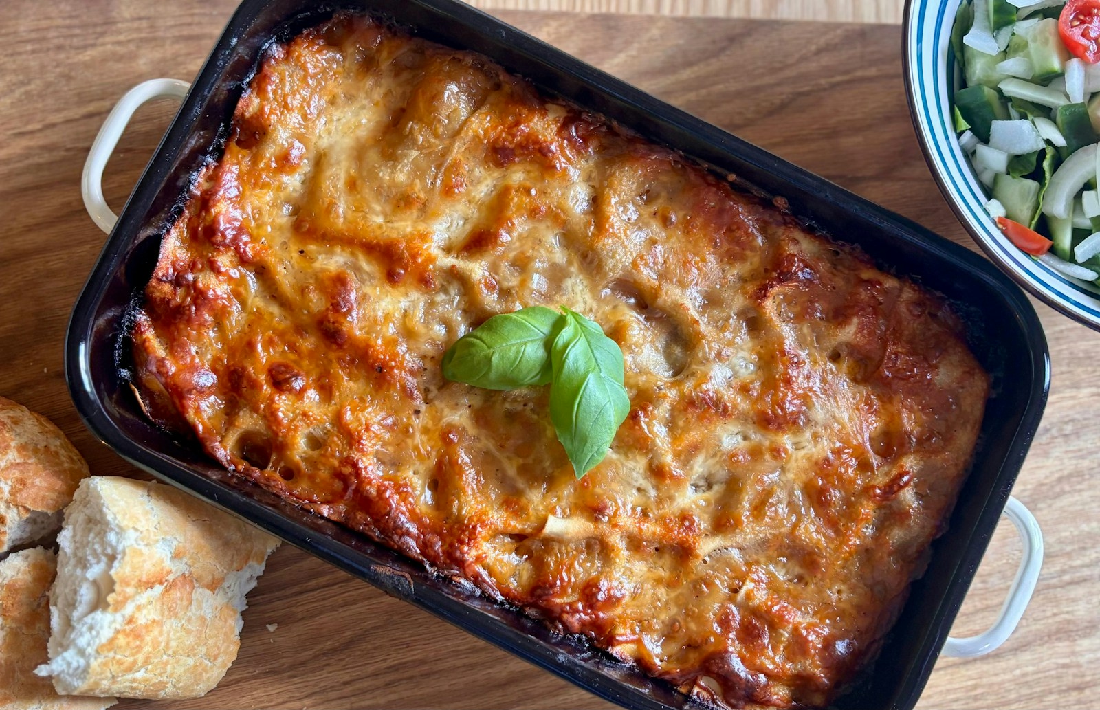 Freshly baked lasagna with a basil leaf garnish