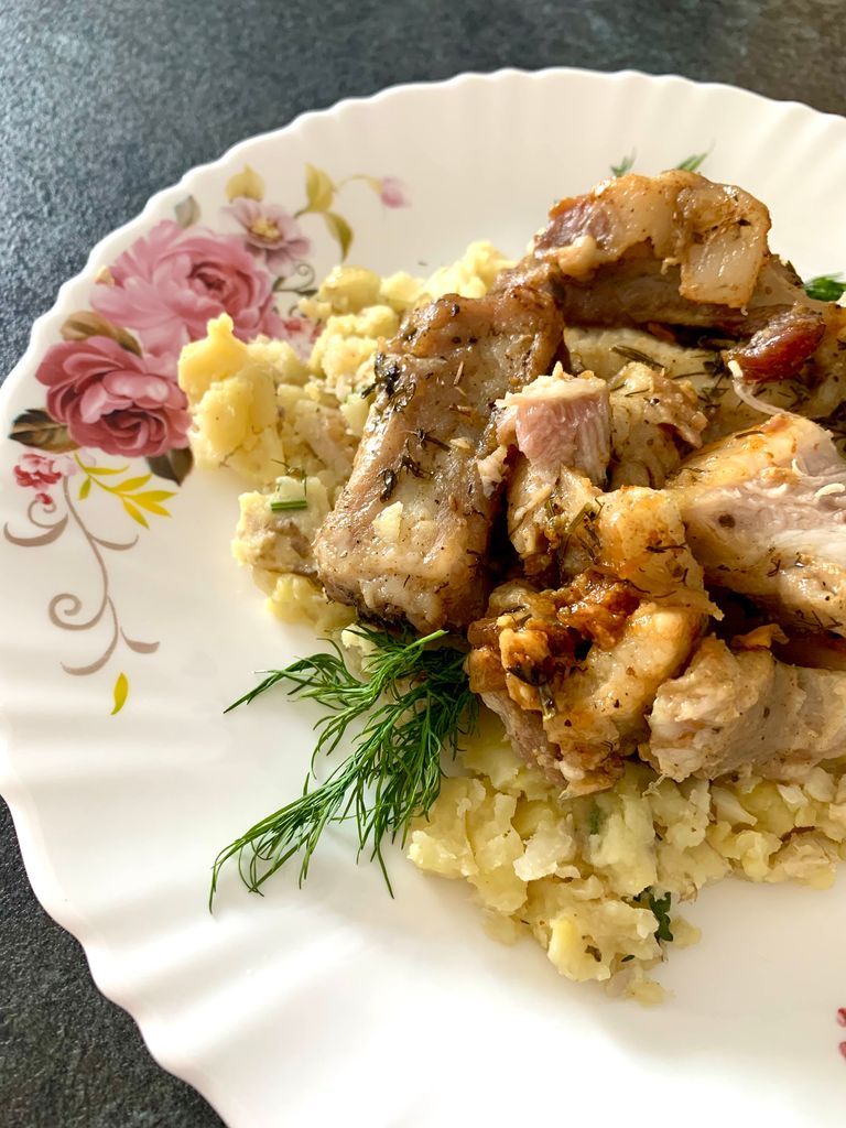 Savory grilled pork served with creamy mashed potatoes on a floral plate