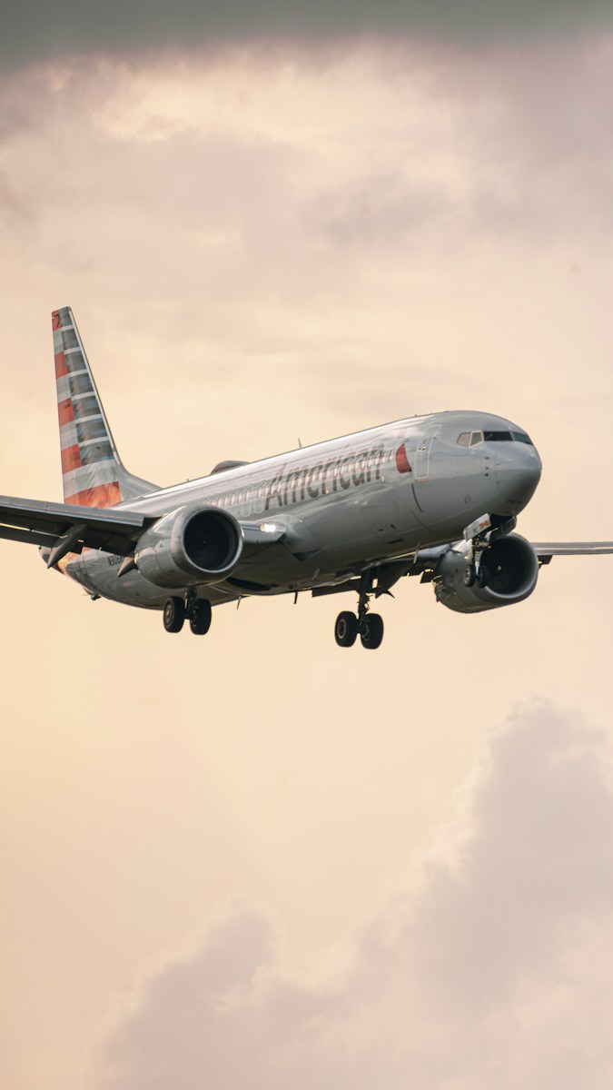 an airplane flying in the sky with a cloudy background