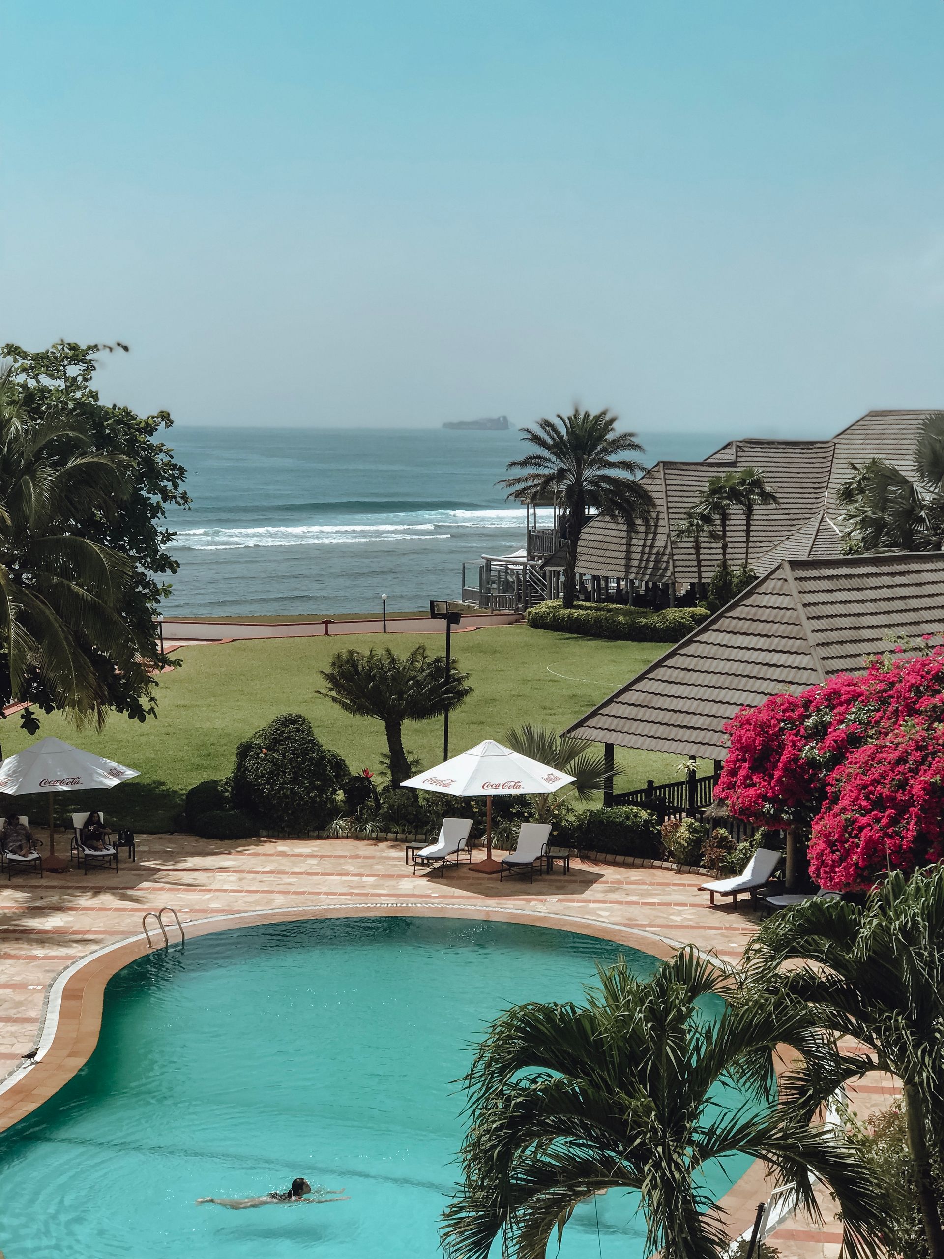 Serene poolside retreat by the ocean in Tanzania, perfect for relaxation.