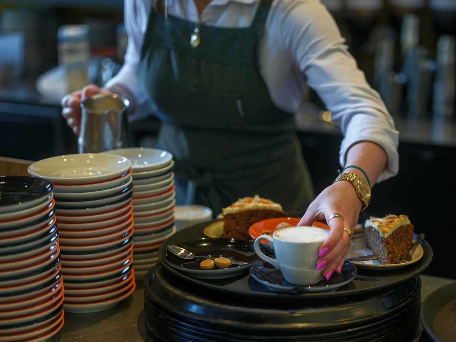 A waitress serves cake and coffee