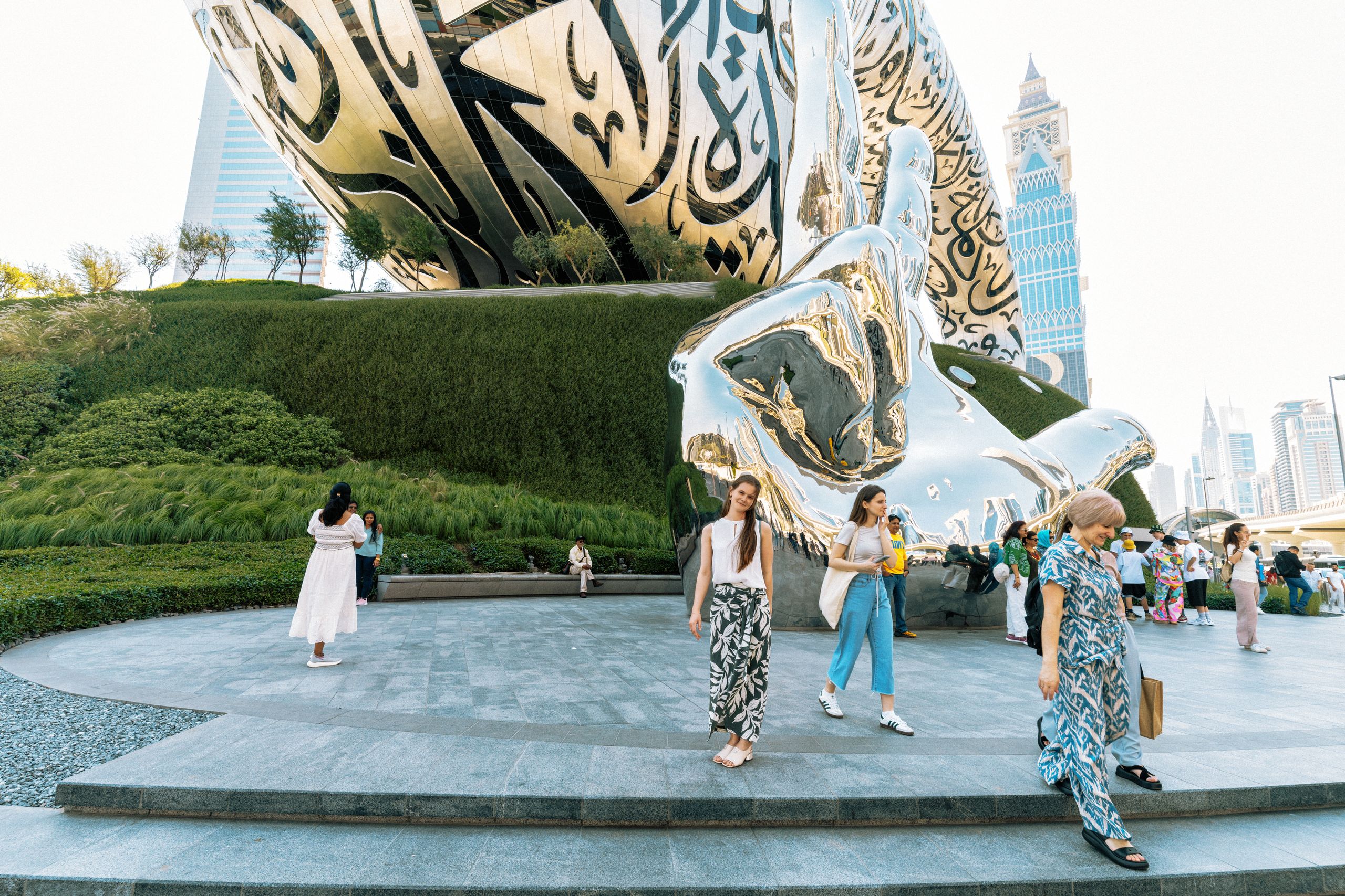 Tourists enjoying the iconic Museum of the Future in Dubai with modern architecture.