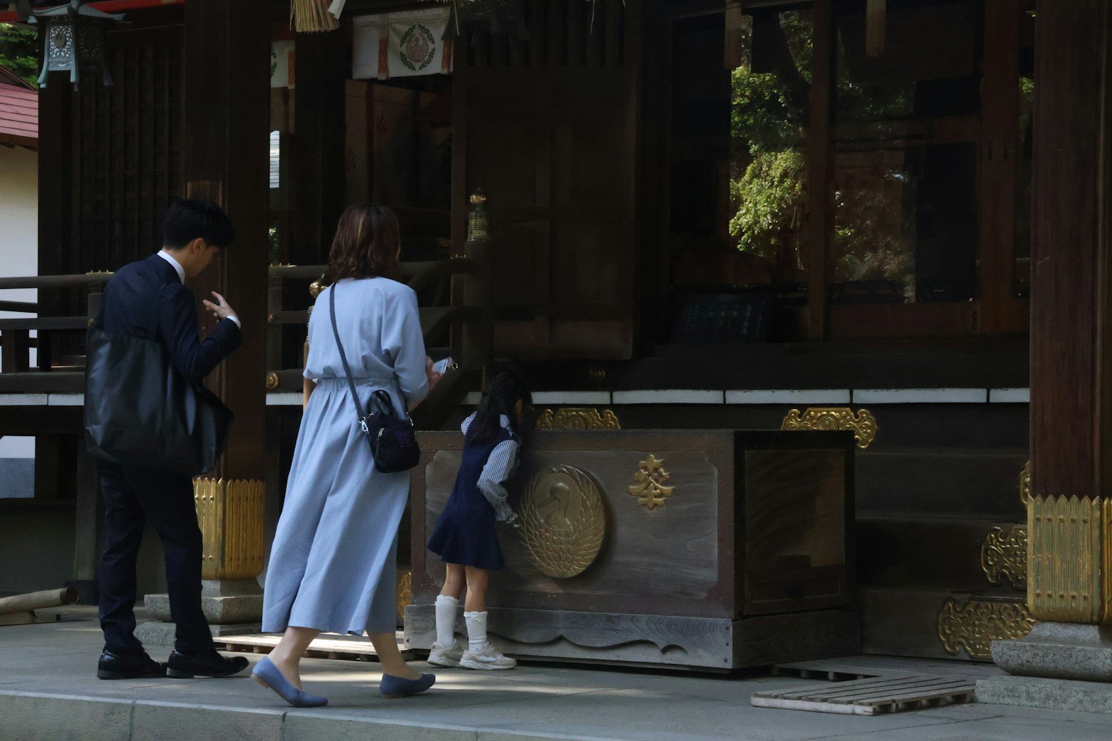 A family is praying at a temple