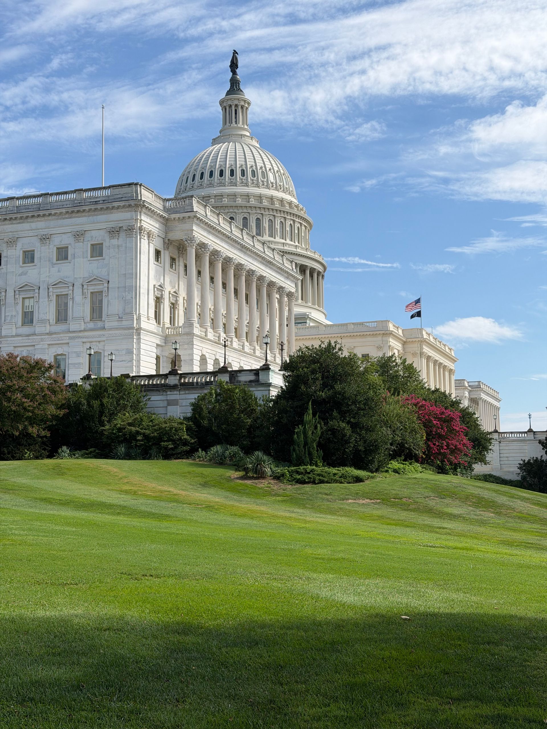 View of the iconic United States Capitol Building with lush gardens, Washington, DC.