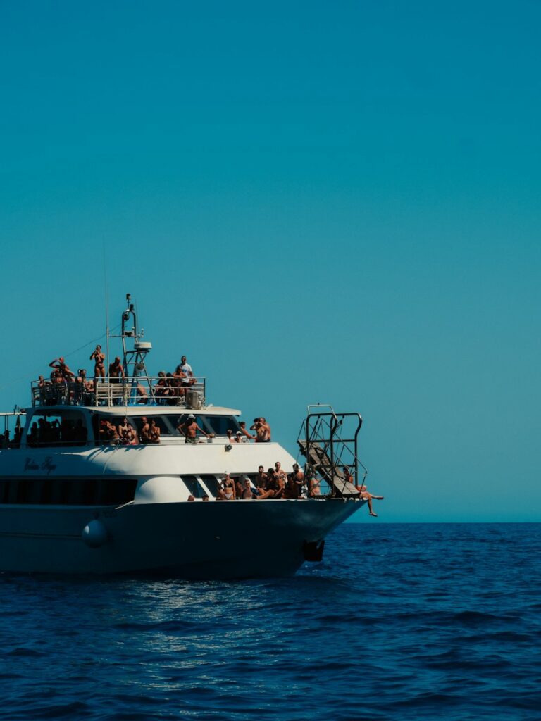 Tour boat filled with people sailing on the ocean