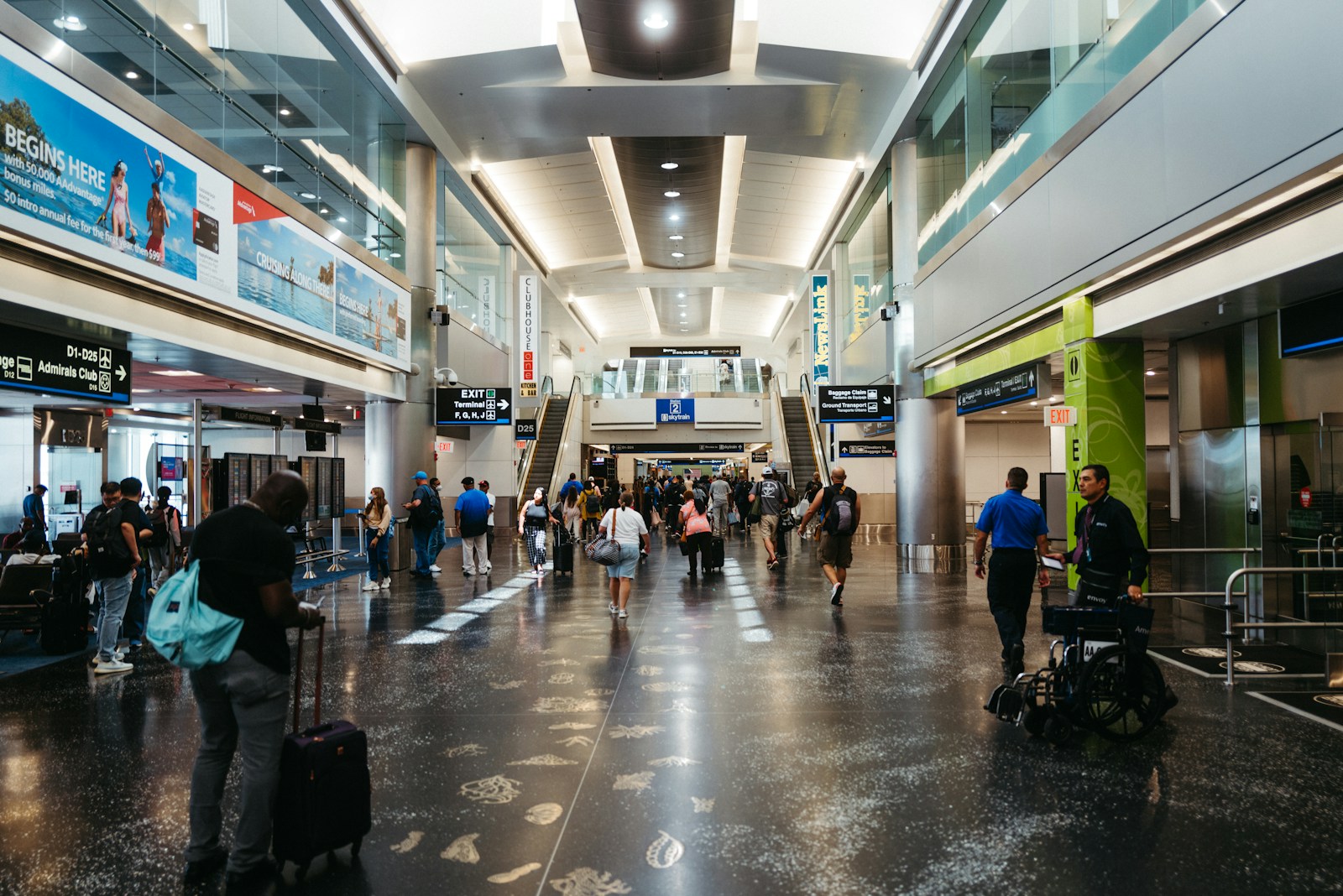 a group of people walking through an airport