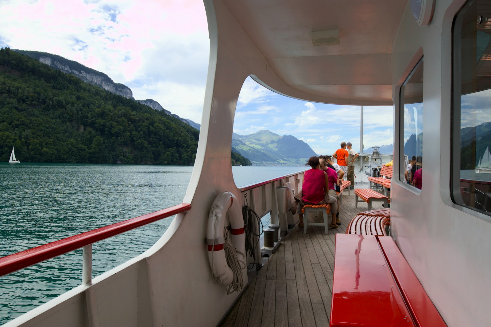Scenic boat ride on a lake surrounded by green mountains