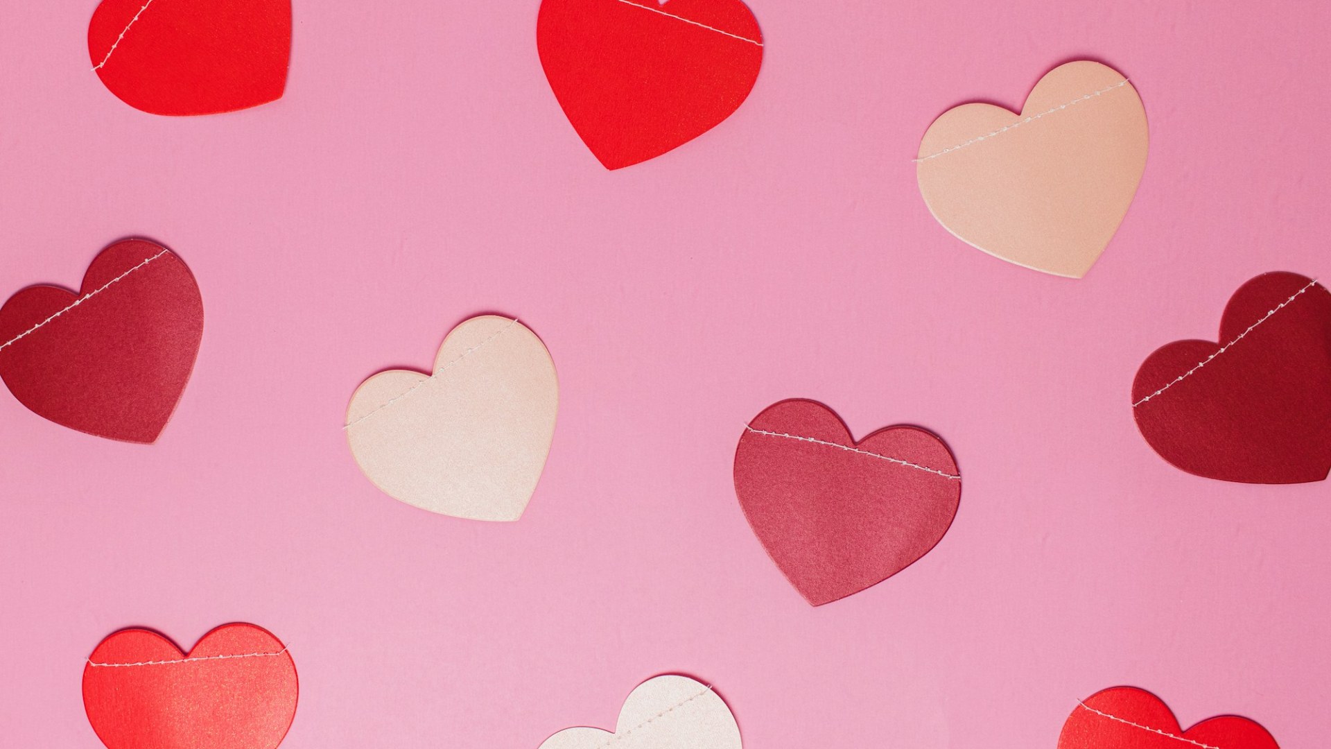 Pink and white paper hearts. Photo by Rinck Content Studio on Unsplash.