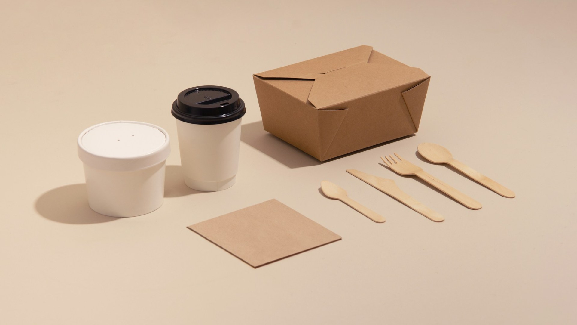A takeout box and a cup of coffee. Photo by Clair on Unsplash.