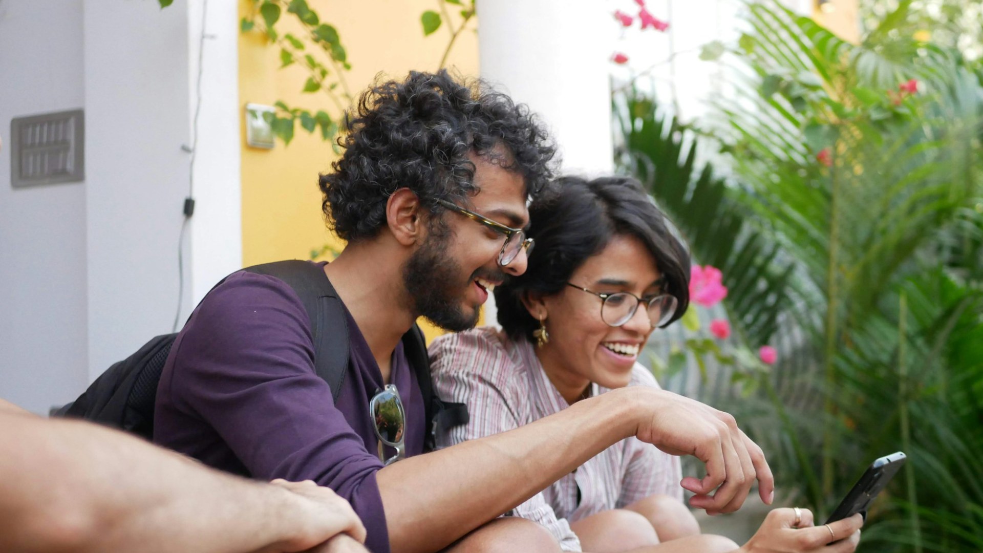 A man and a woman laughing at a smartphone. Photo by Karthik Balakrishnan on Unsplash.
