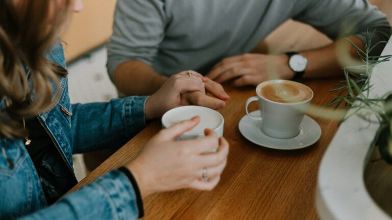 Two mugs of coffee on a table. Photo by Priscilla Du Preez on Unsplash.