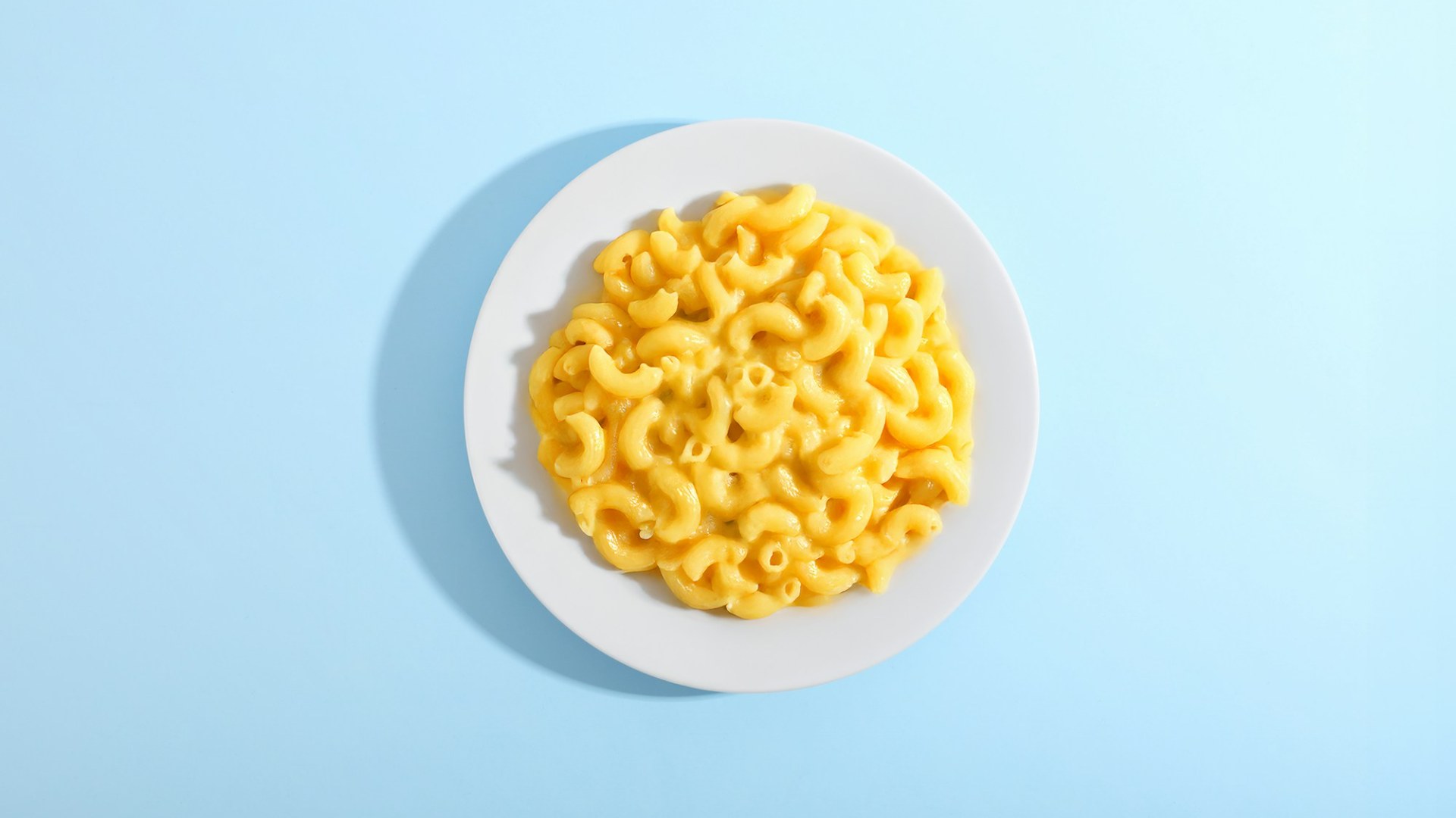 Mac and cheese on a white plate. Photo by Giorgio Trovato on Unsplash.