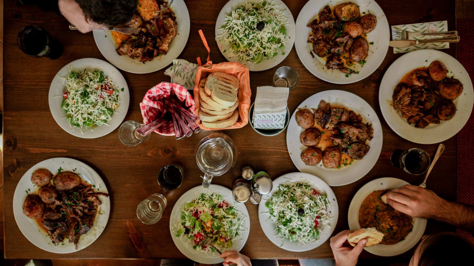 White plates with assorted foods. Photo by Stefan Vladimirov on Unsplash.