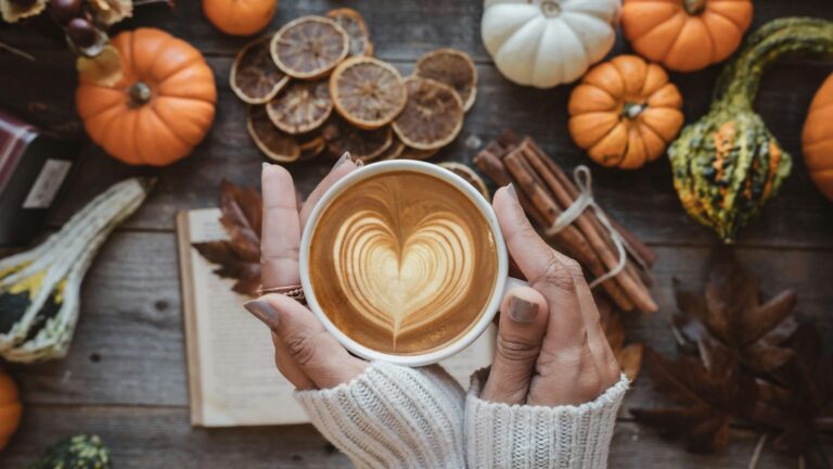 A person holding a cup of coffee with a heart on it. Photo by Prchi Palwe on Unsplash.