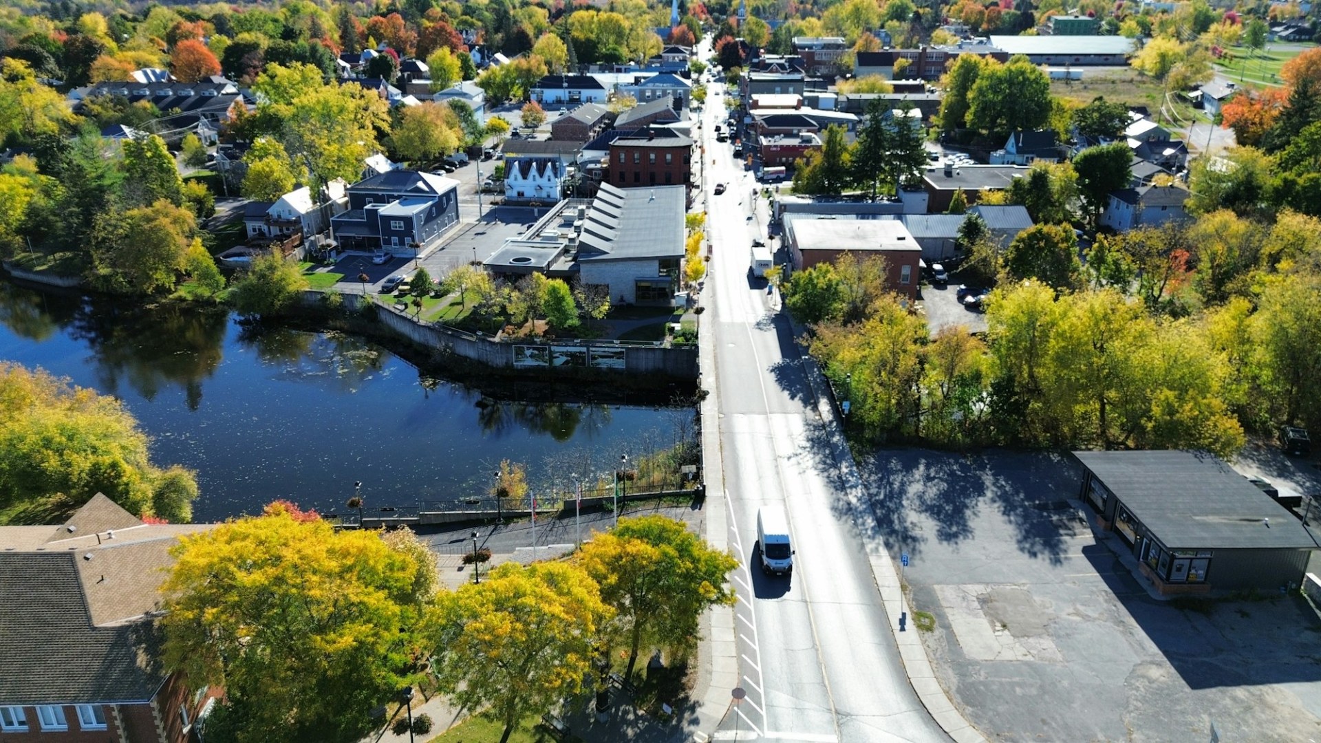 An aerial view of a small town with autumn foliage. Photo by Driscoll-Peca Real Estate Team on Unsplash.