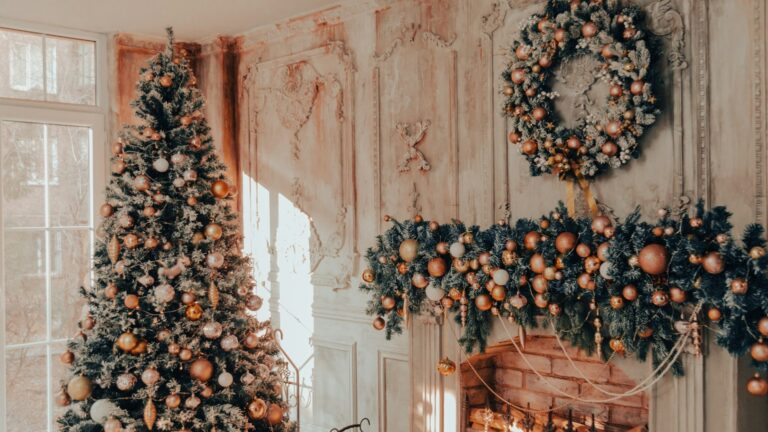 A Christmas tree and wreaths beside a fireplace. Photo by Collab Media on Unsplash.
