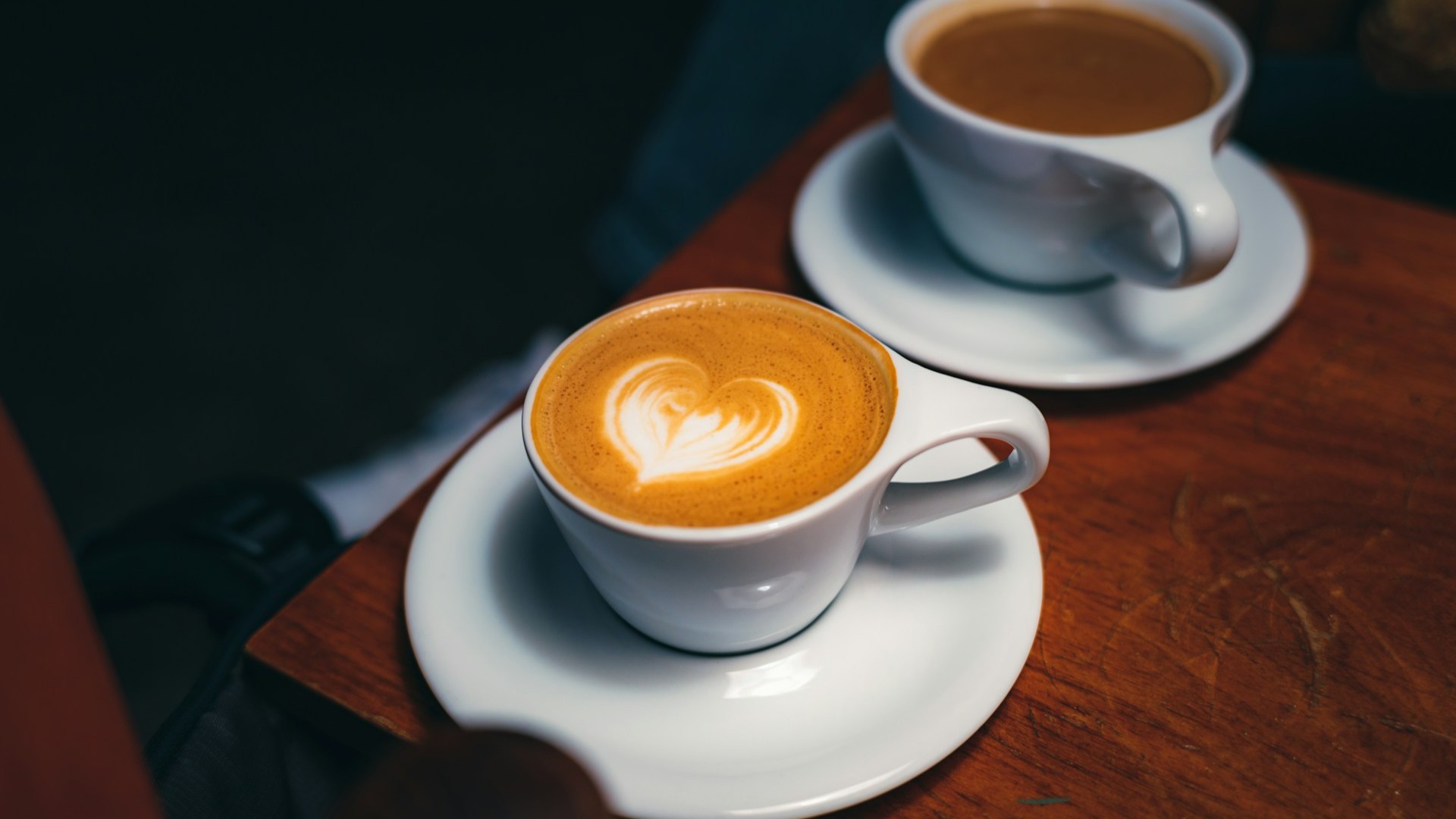 Unsplash photo by Daniel Seßler showing two cups of coffee on a wooden table