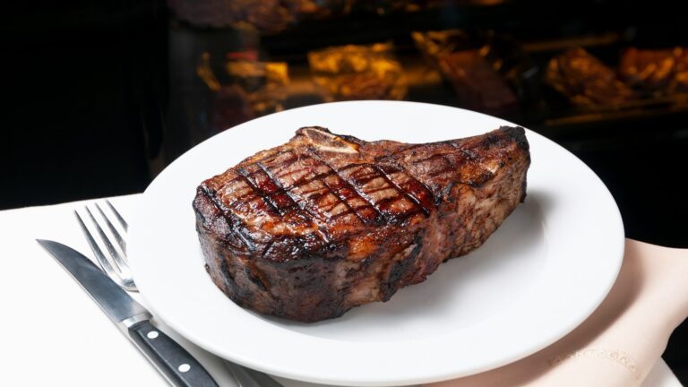 Unsplash photo by Marcelo de la Torre showing a steak on a plate with a fork and knife