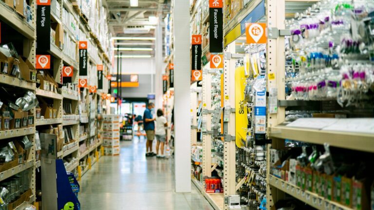 Unsplash photo by Oxana Melis showing a store aisle with shelves full of items