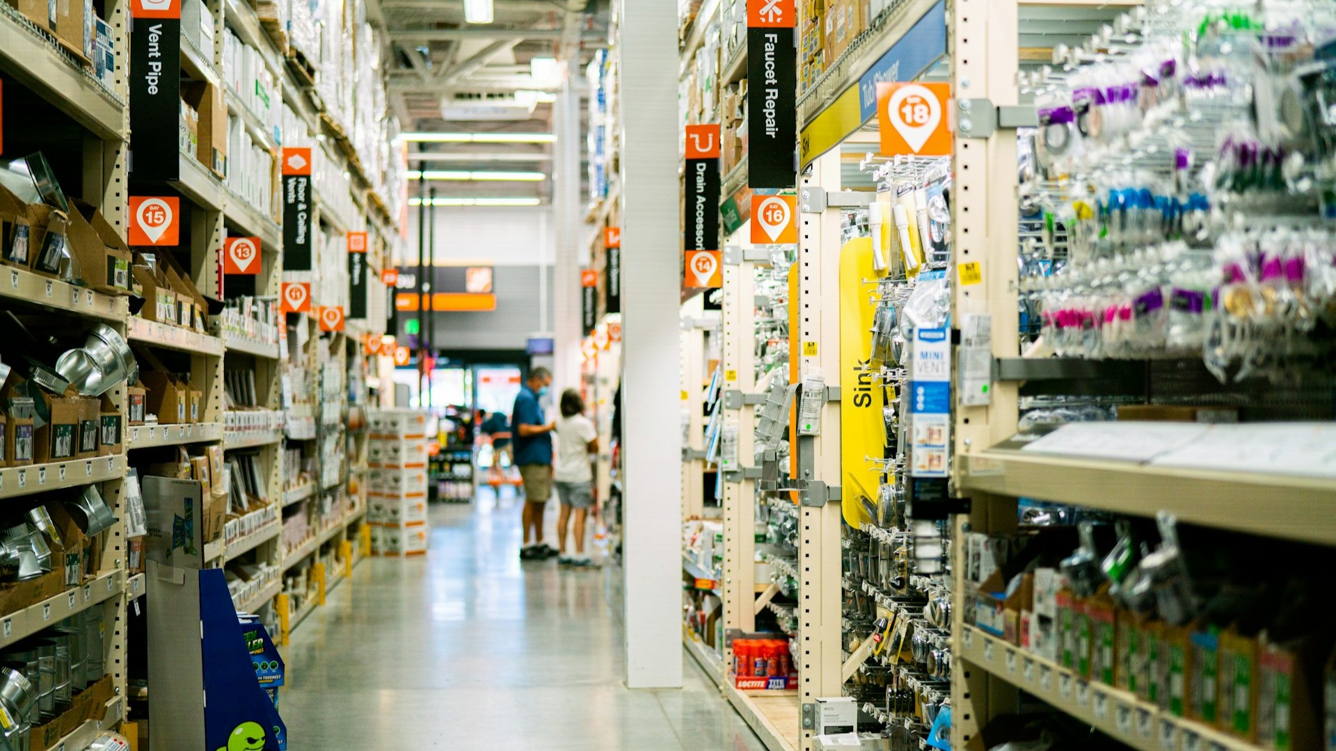 Unsplash photo by Oxana Melis showing a store aisle with shelves full of items