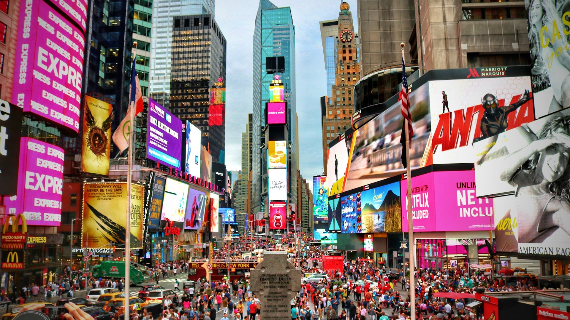 Unsplash photo by Jorge Fernández Salas showing a crowded Times Square street lined with tall buildings