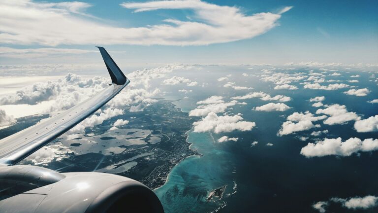 Unsplash photo by Patrick Tomasso showing an airplane wing against a blue sky in daytime